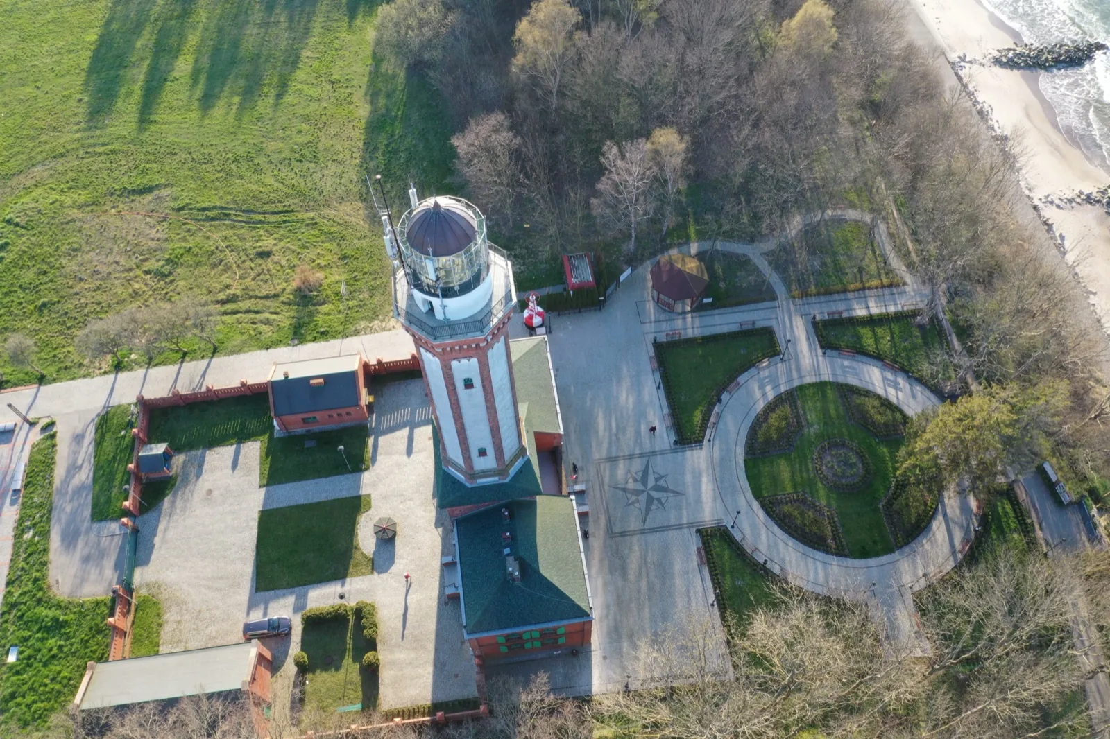 Latarnia Morska Niechorze z lotu ptaka — wieża z 1866 r. w parku, klif nad Bałtykiem